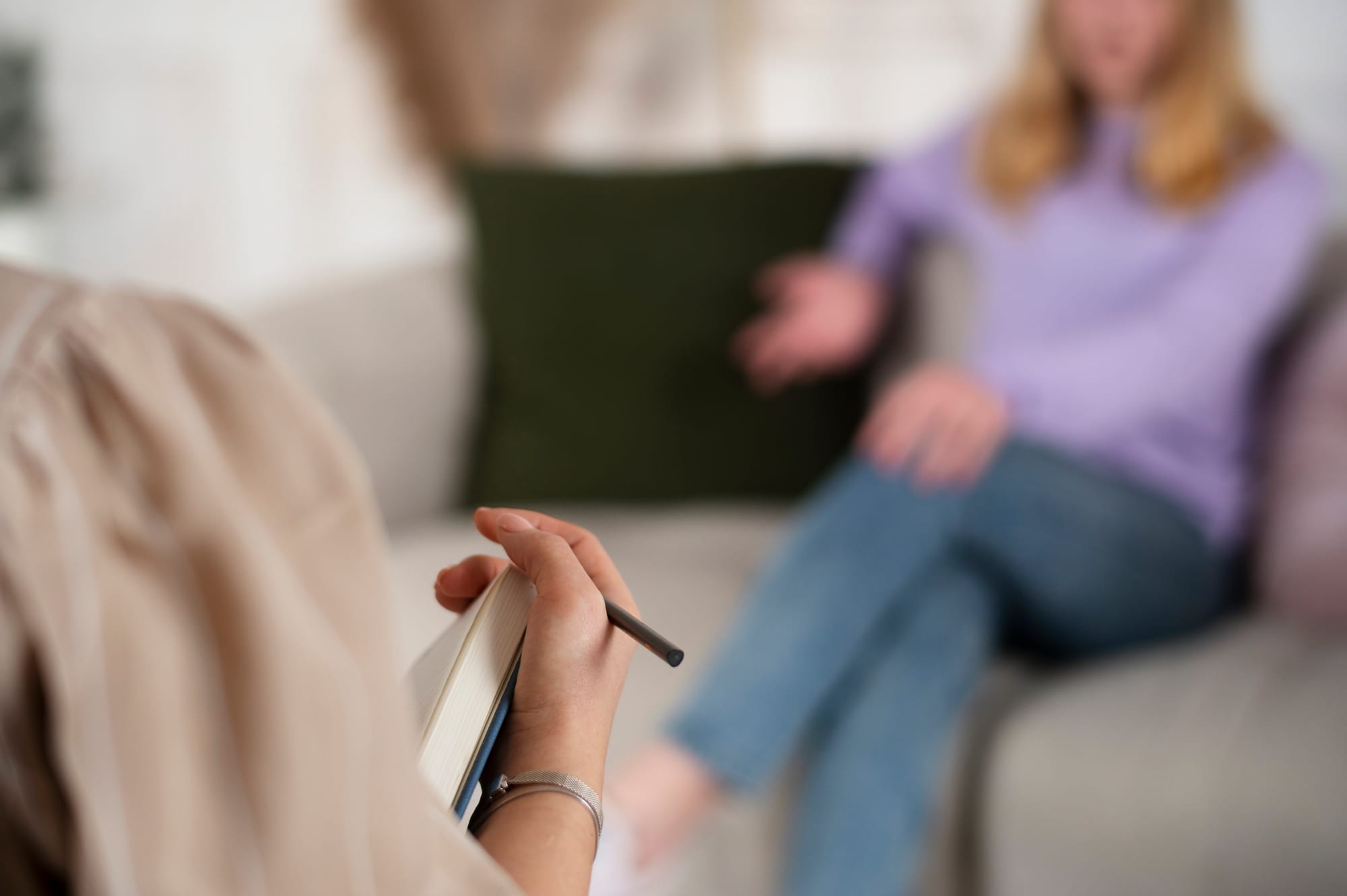 A practitioner taking notes during a session